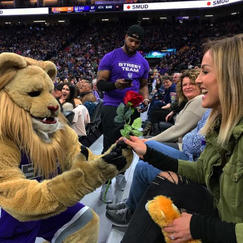 A Sacramento Kings mascot gives a red rose to Clare Crawley.